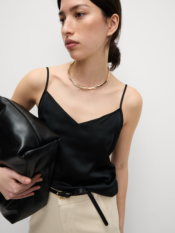 Woman wearing black satin cami top