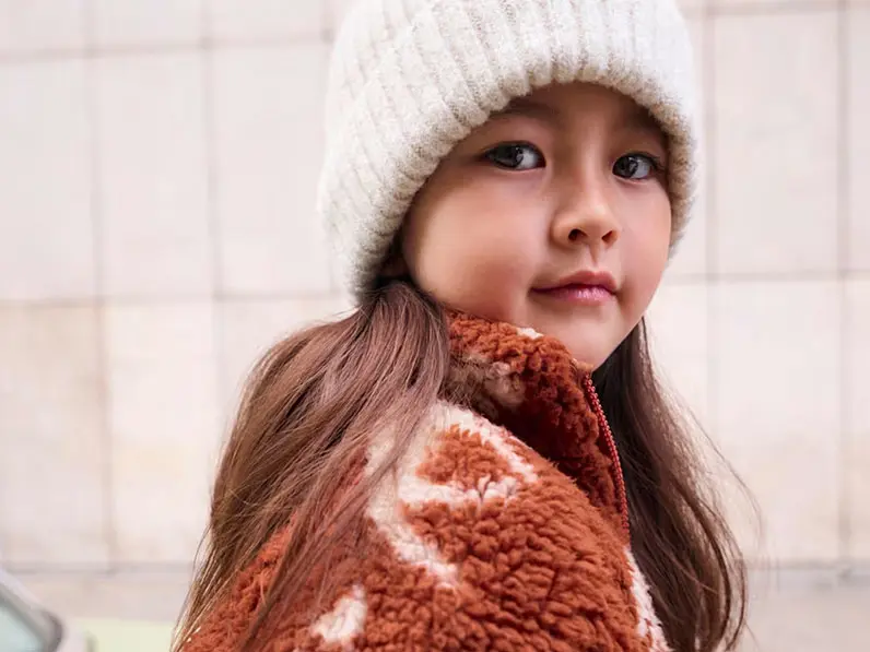 Girl in orange coat and hat