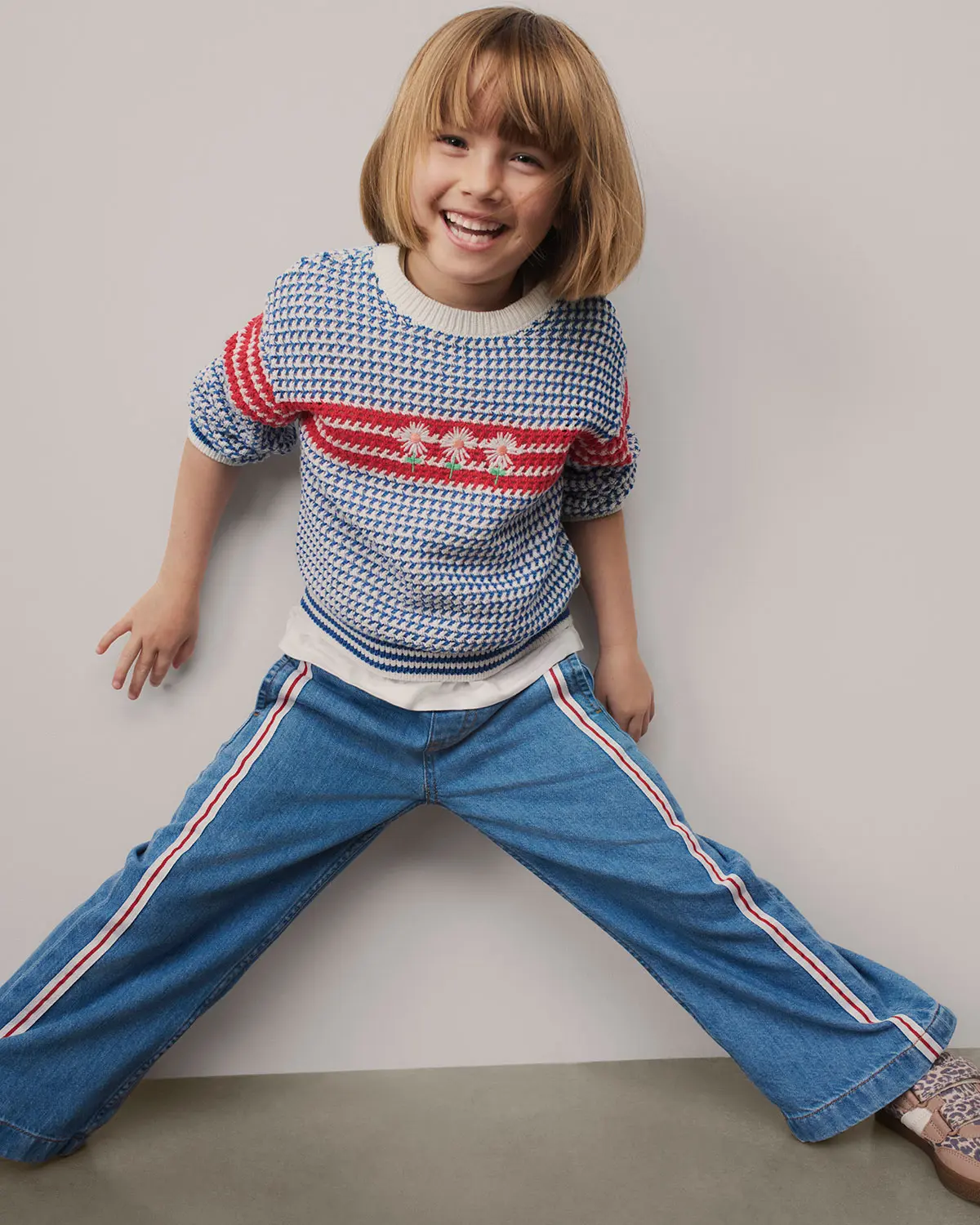 Girl wearing striped jumper and jeans at M&S