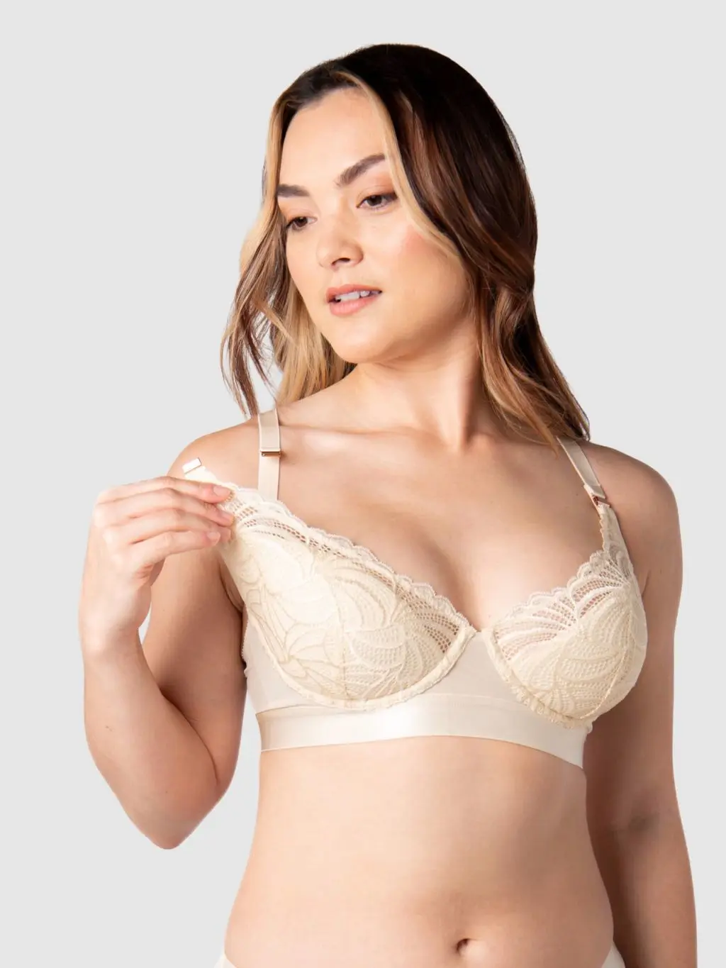 A woman undoing a nursing bra