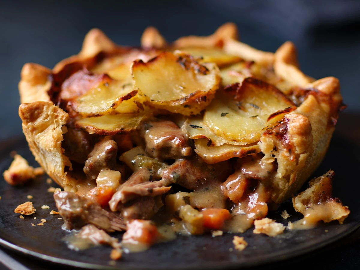 Steak pie cut open with black background
