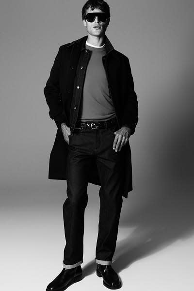 Man wearing coat, jeans & jumper