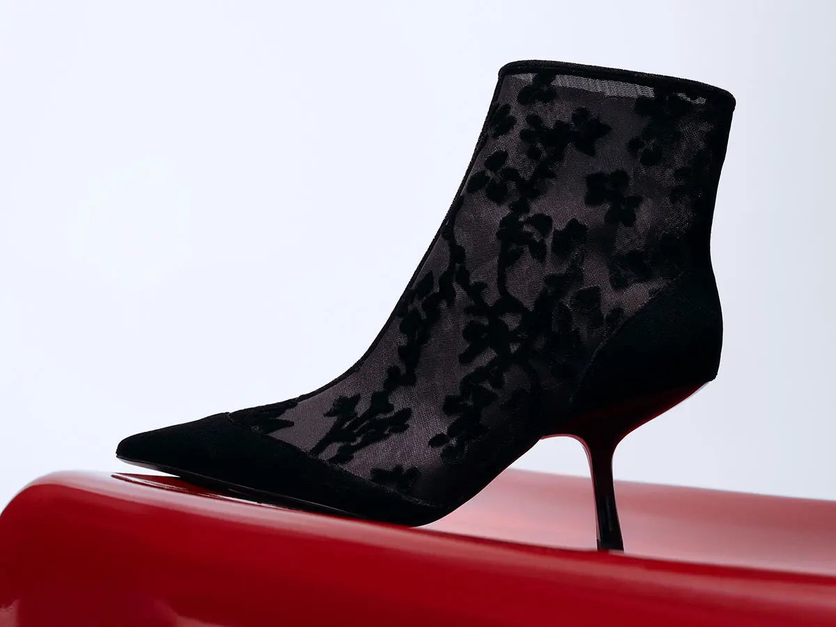 Black heeled ankle boot with pointed toe and lace detailing 