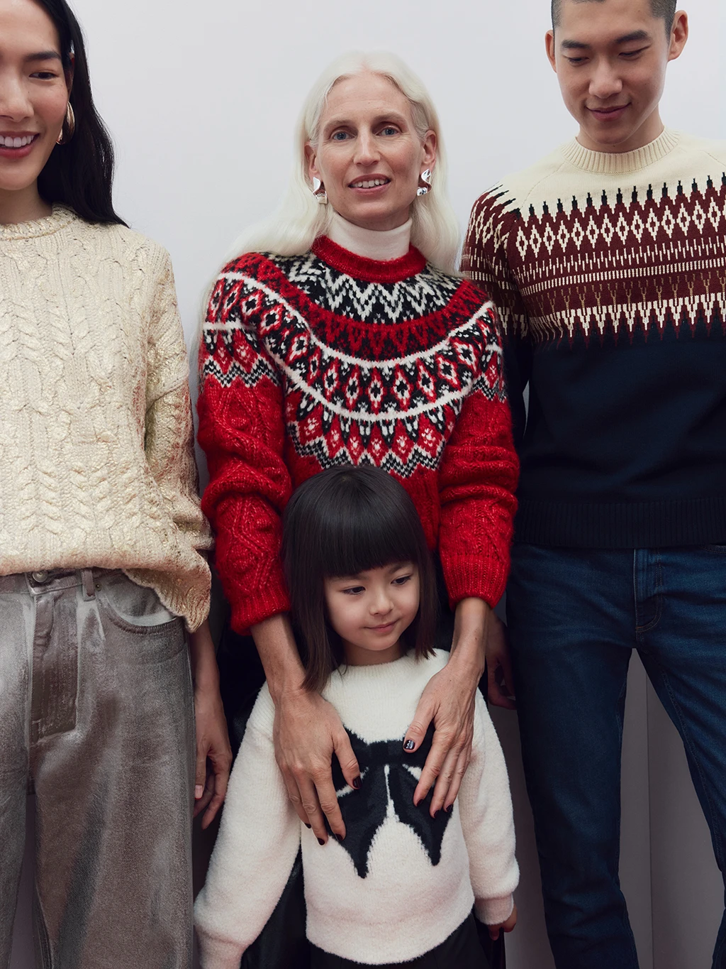 Family wearing assorted Christmas jumpers