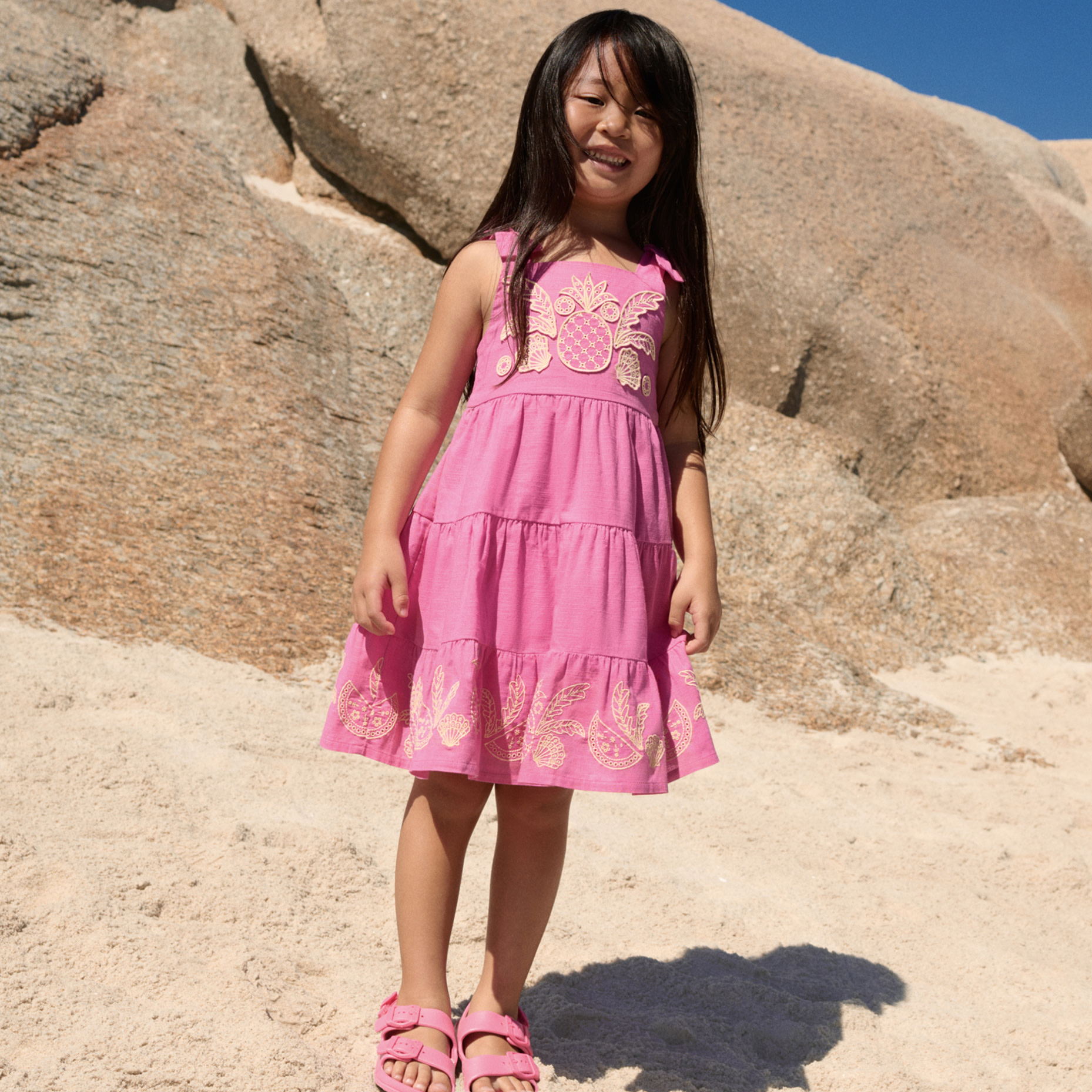 Girl wearing pink dress and pink sandals 