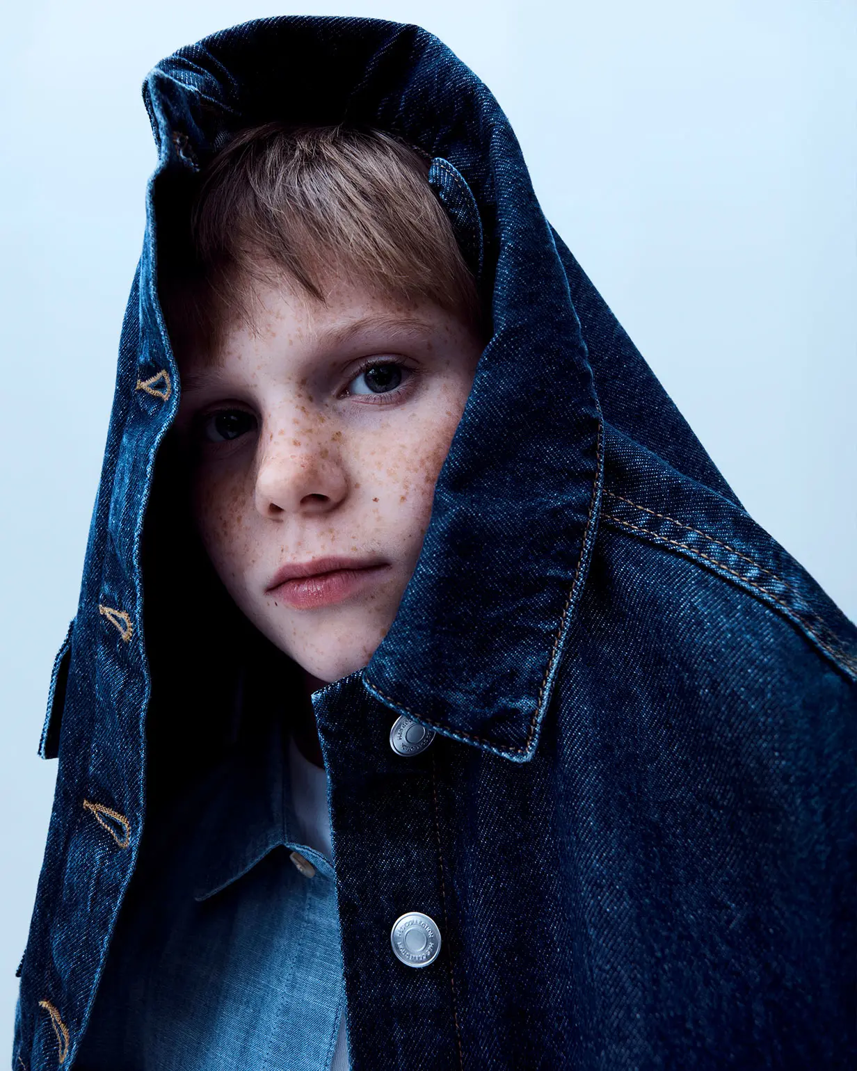 Boy wearing dark blue denim jacket