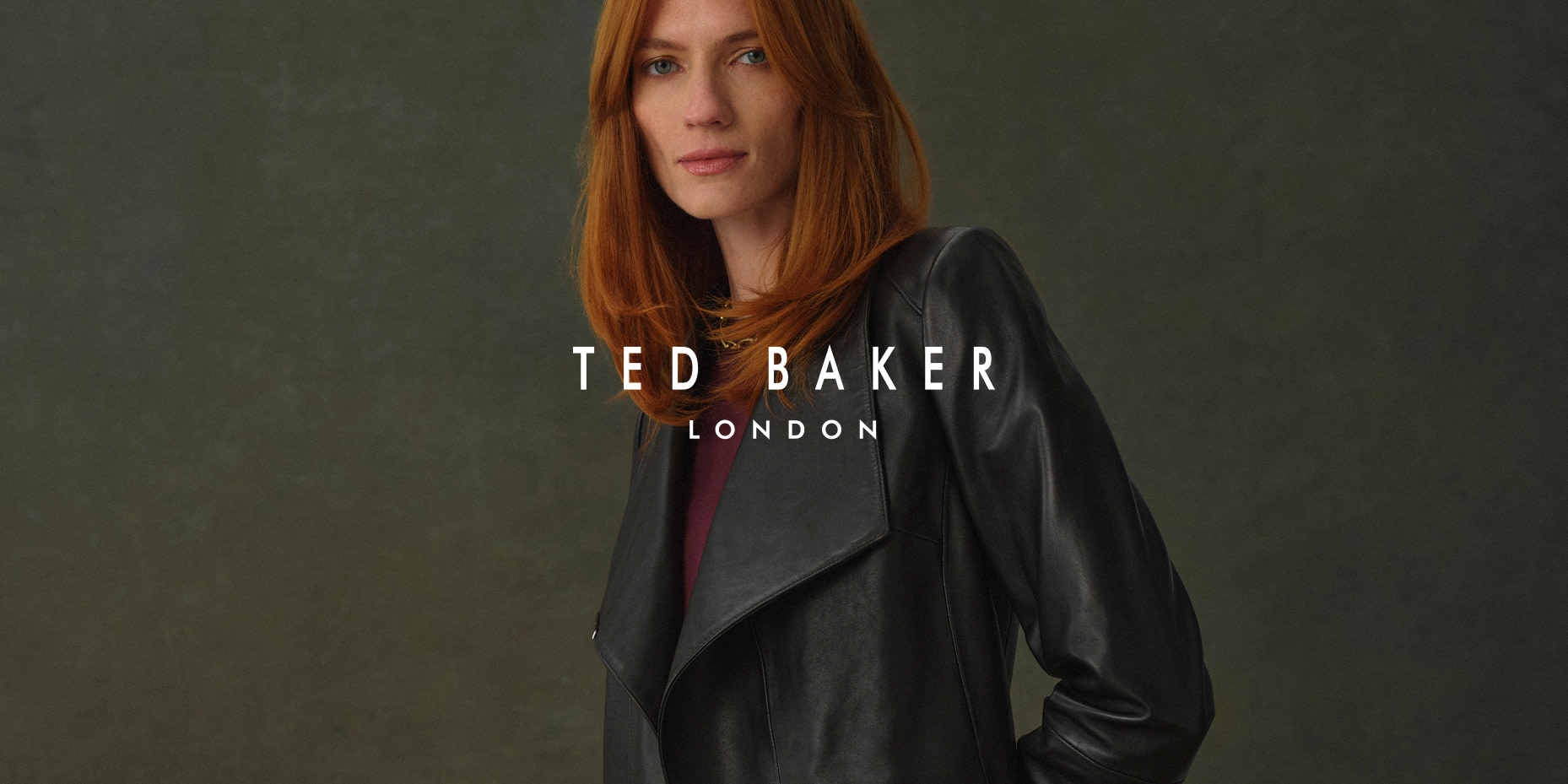 Woman wearing back leather jacket by Ted Baker