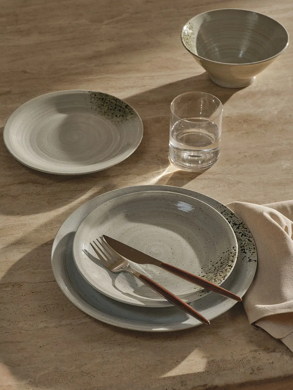Plates, forks and glasses on table