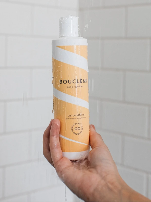 Bottle of shampoo for curly damaged hair