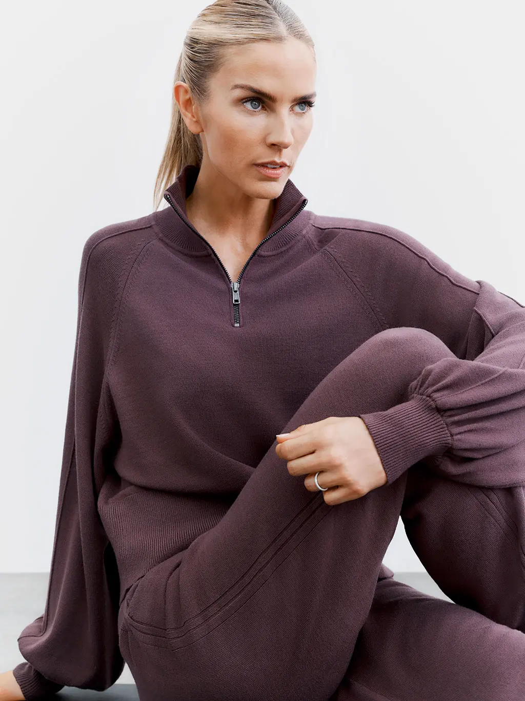 Woman in purple hoodie and joggers
