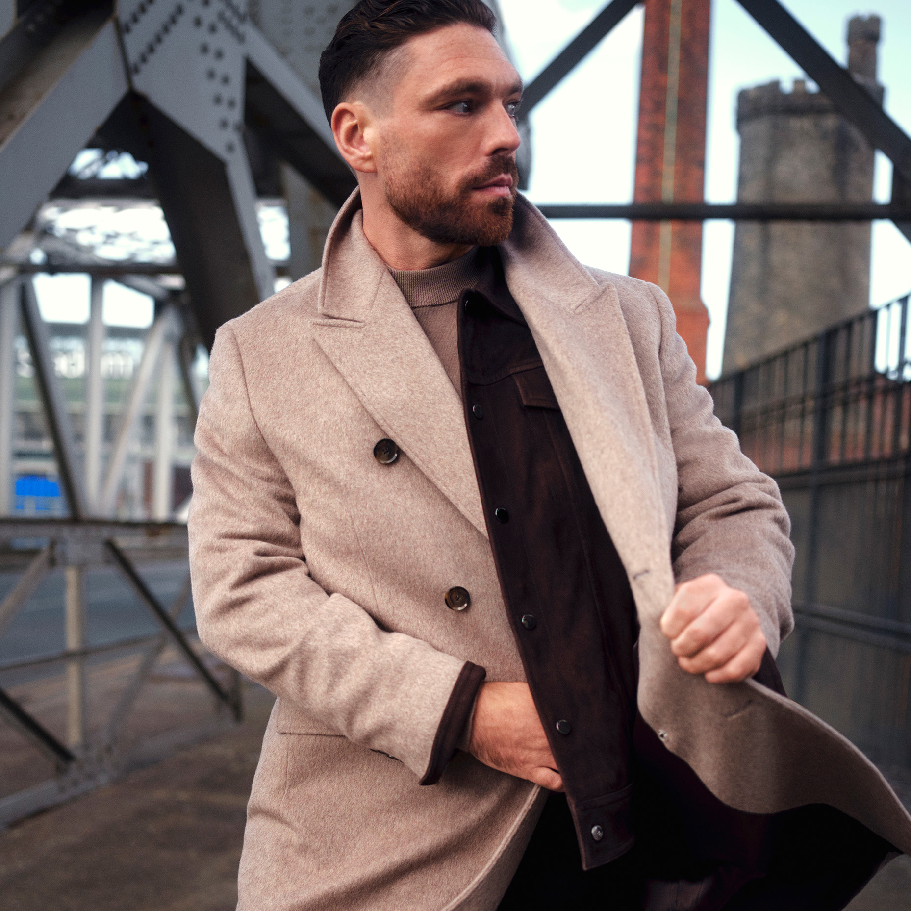 Man wearing light brown coat and brown shirt