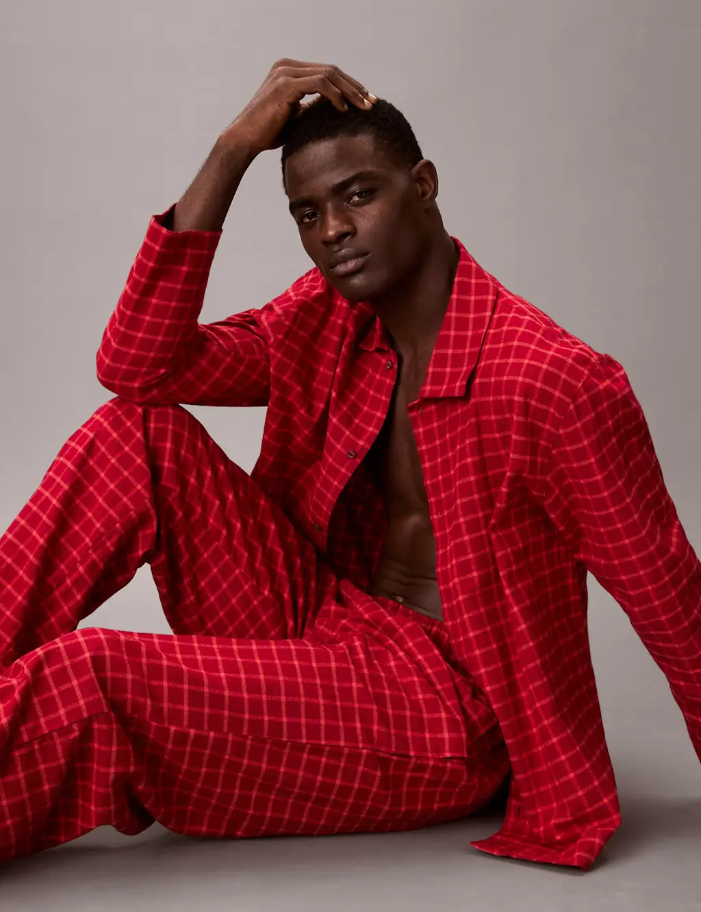 Man wearing red Calvin Klein pyjamas