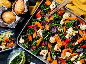 A traybake of autumn vegetables and jacket potatoes