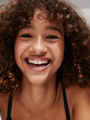 Teenage girl smiling. Book a first bra fit
