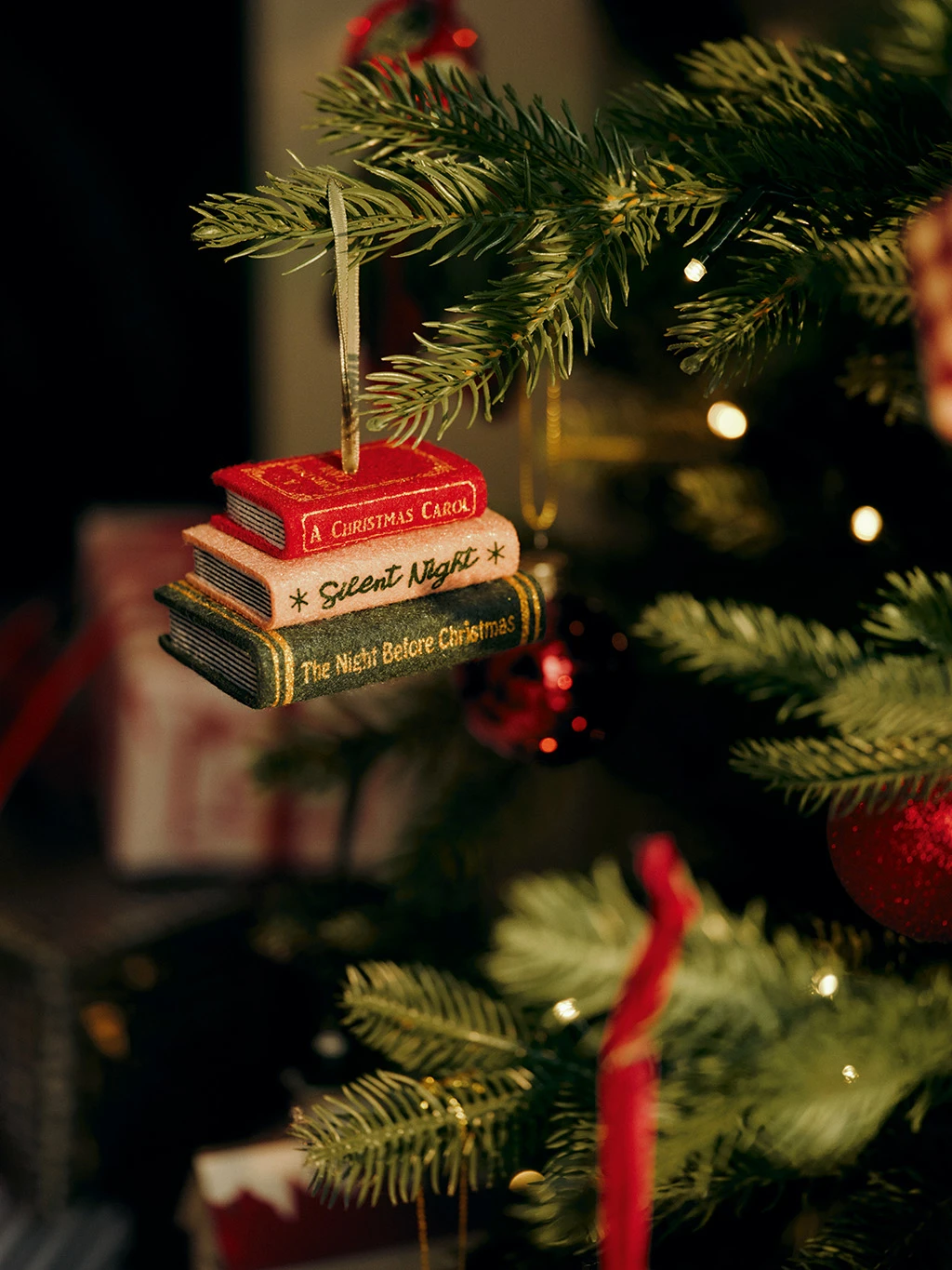 Christmas tree decoration with a stack of three books.