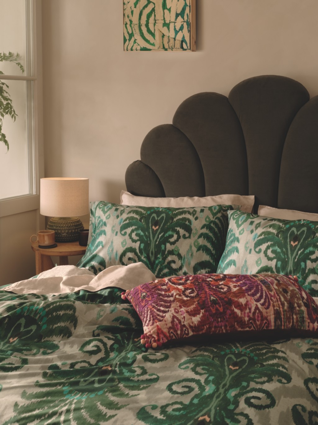 Bed made with a vibrant, boldly patterned green and white duvet set. Shop the Casual Cabana trend