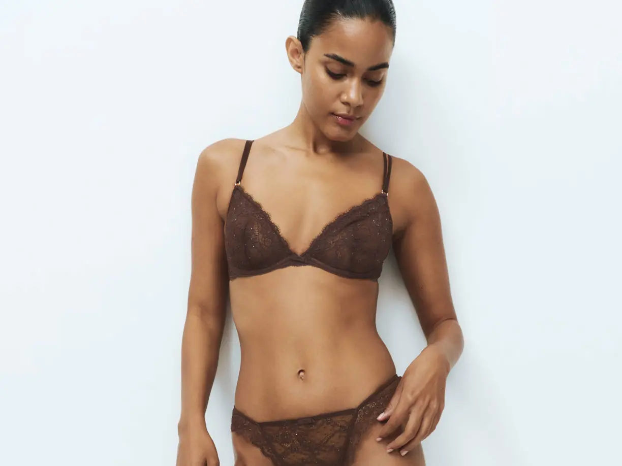 Woman wearing dark brown bra and underwear set