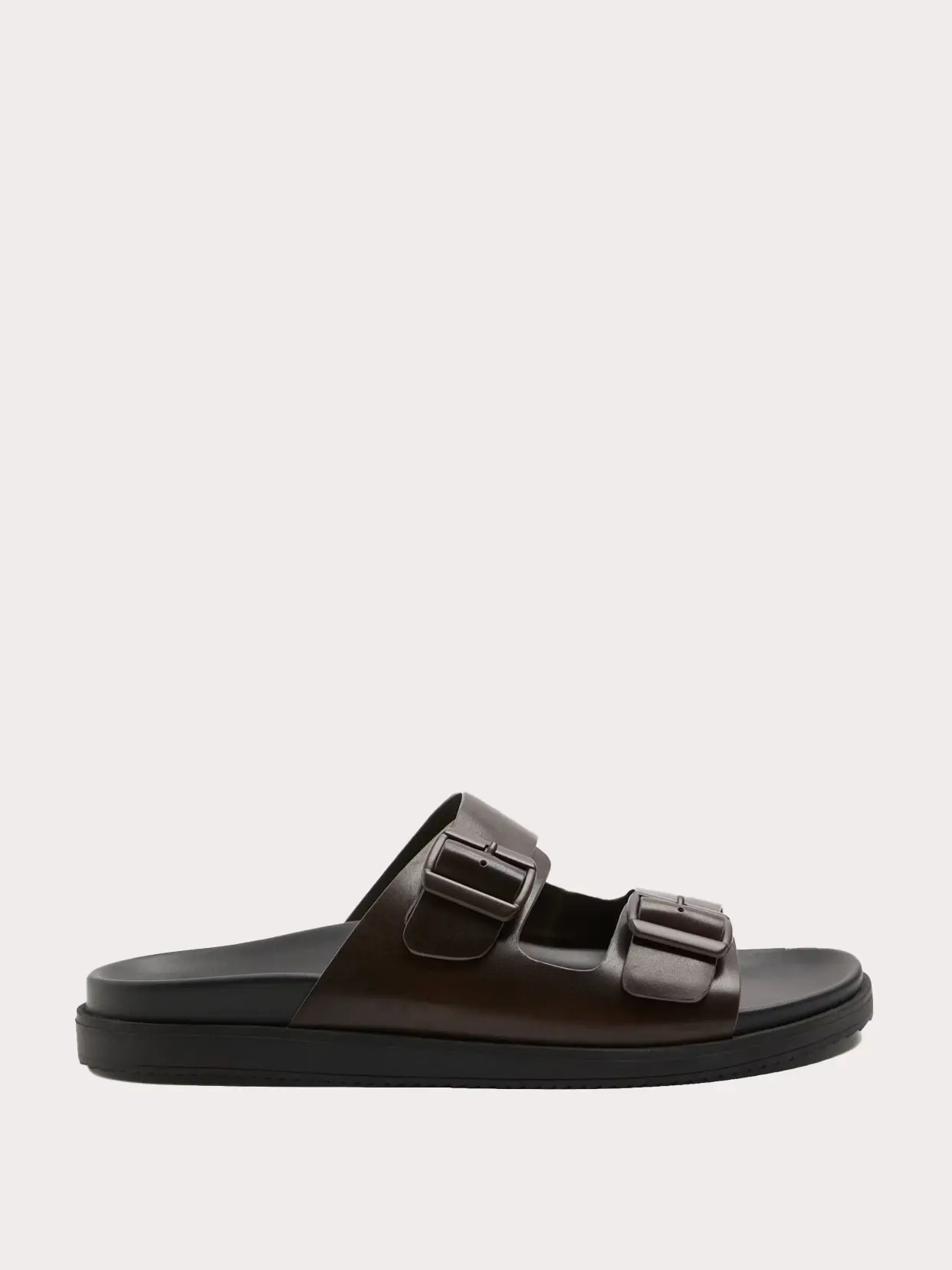 Dark brown leather sandal with two straps and buckle details 
