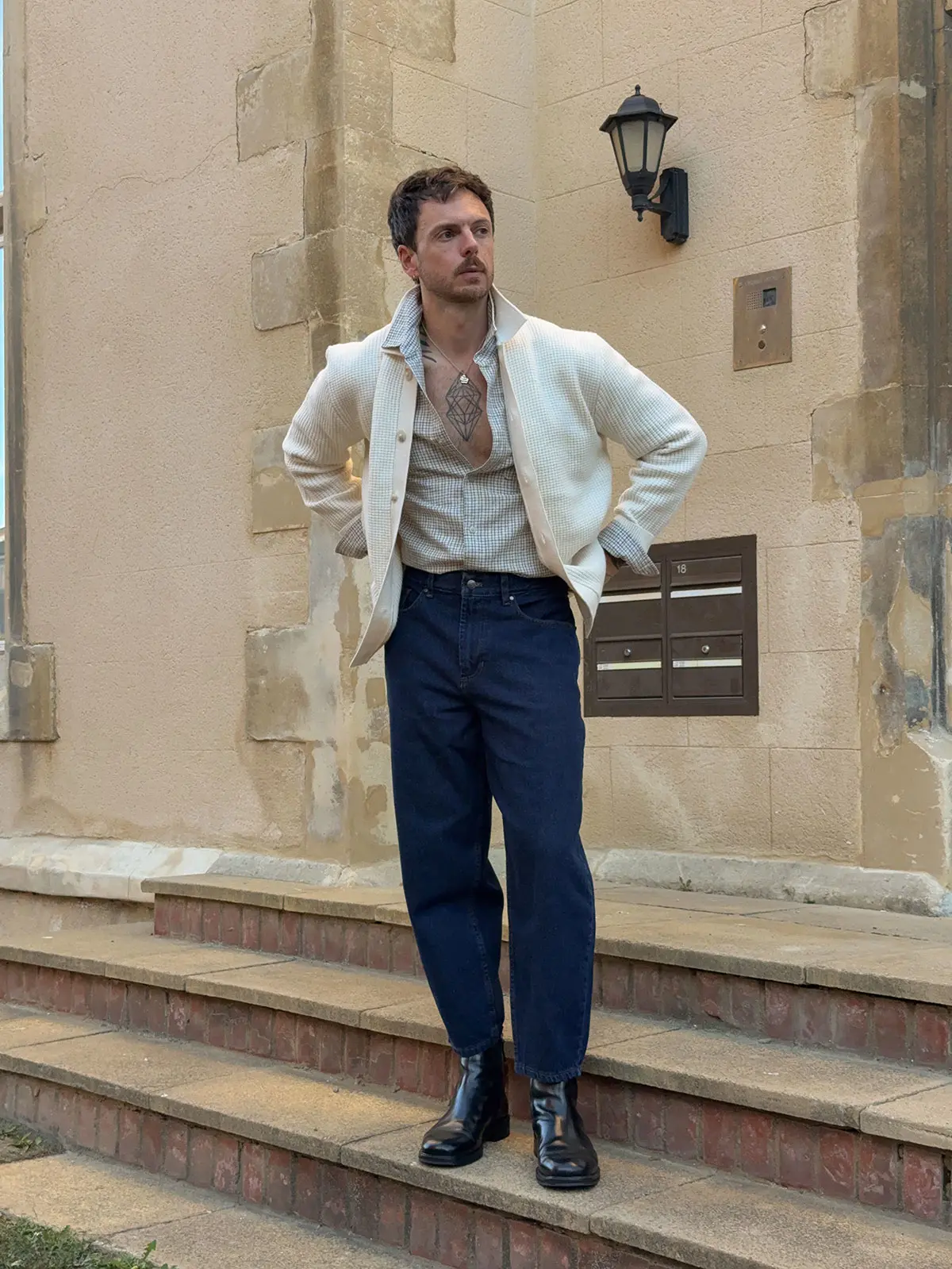 Influencer Nick Howard-Lanes wearing cream cardigan over a shirt and jeans