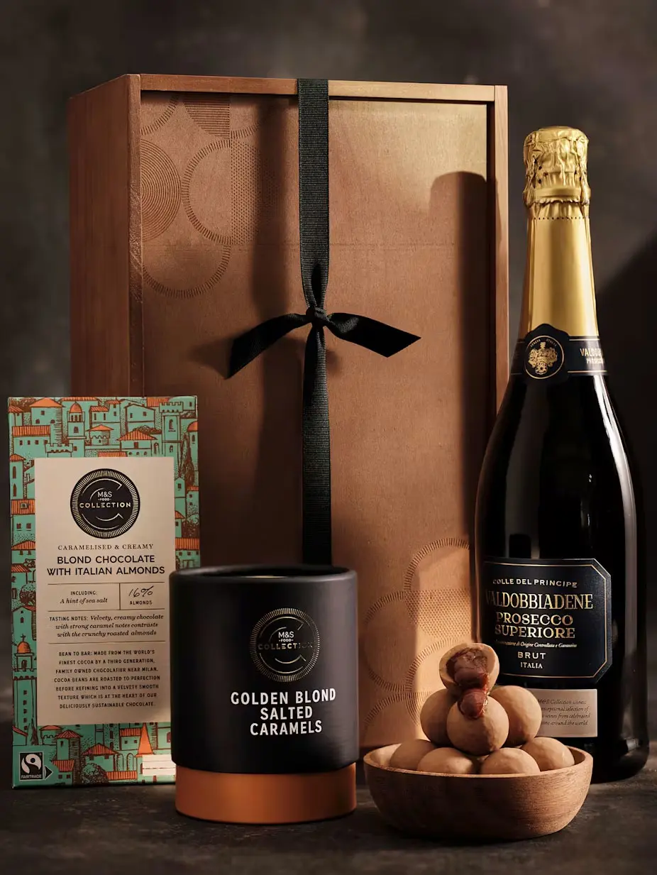 Wooden gift box with prosecco, truffles, and chocolate