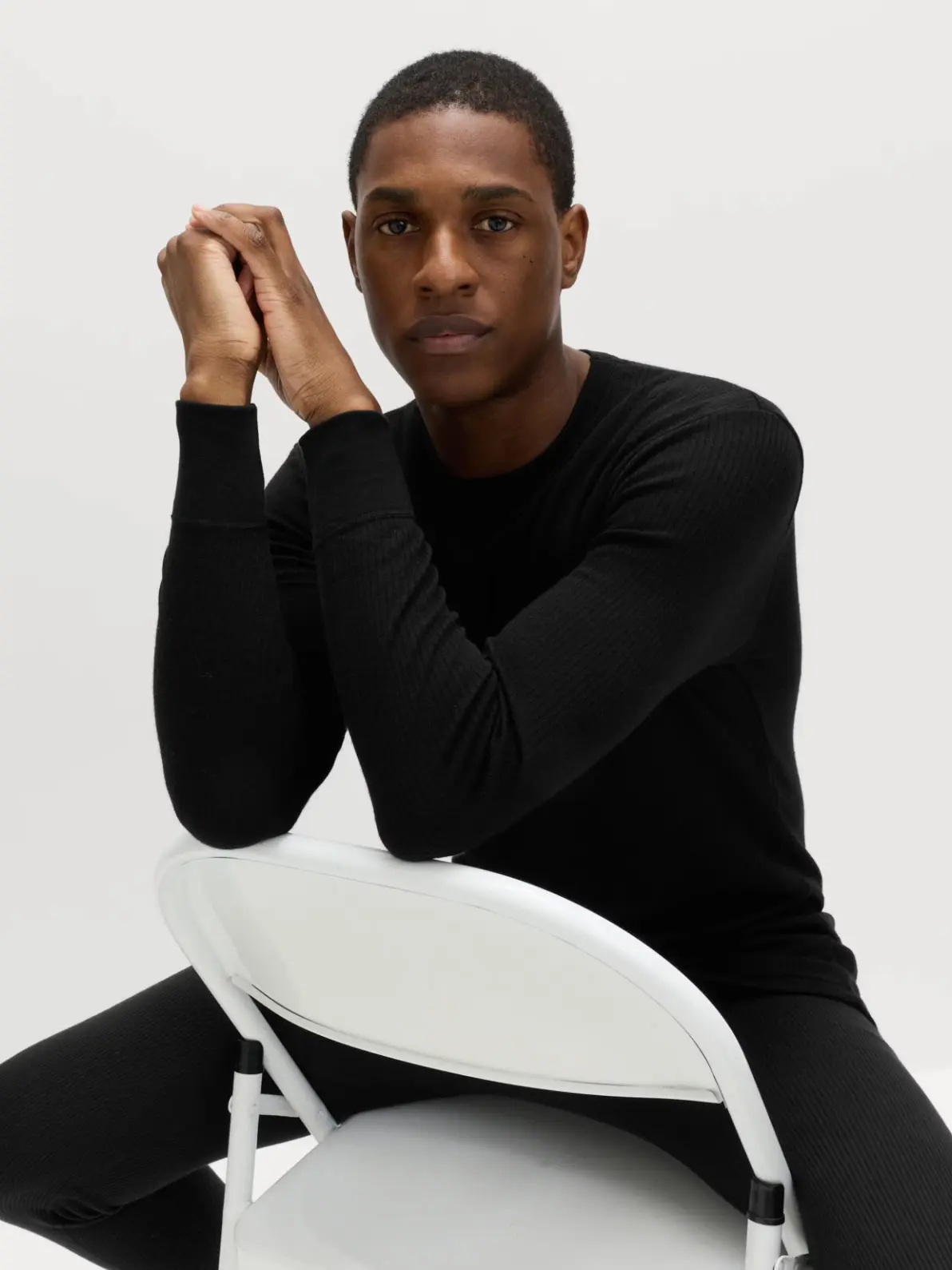 Man wearing black thermal long-sleeve top and matching long johns