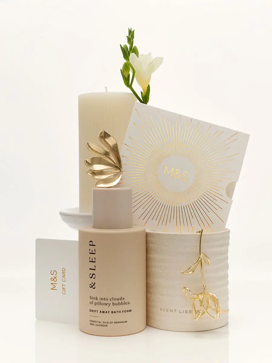 Gift card stacked on top of candle and flowers