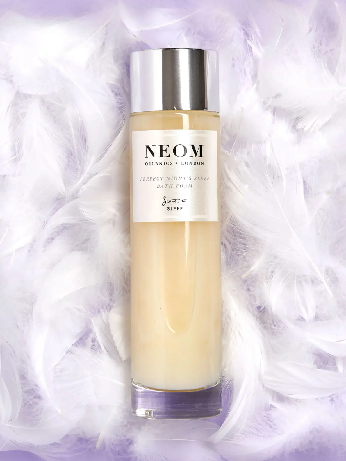 Bottle of sleep bath foam over lilac background