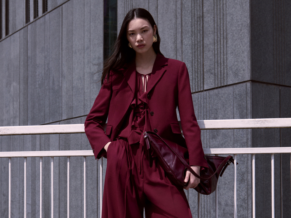 Woman wearing a red suit with a matching red ruffle shirt