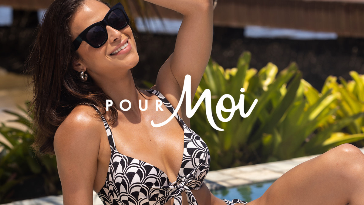 Woman wearing black and white patterned bikini with black sunglasses