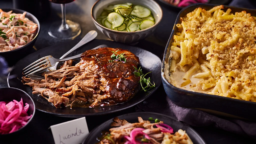Pulled pork, mac and cheese, bowl of pickles