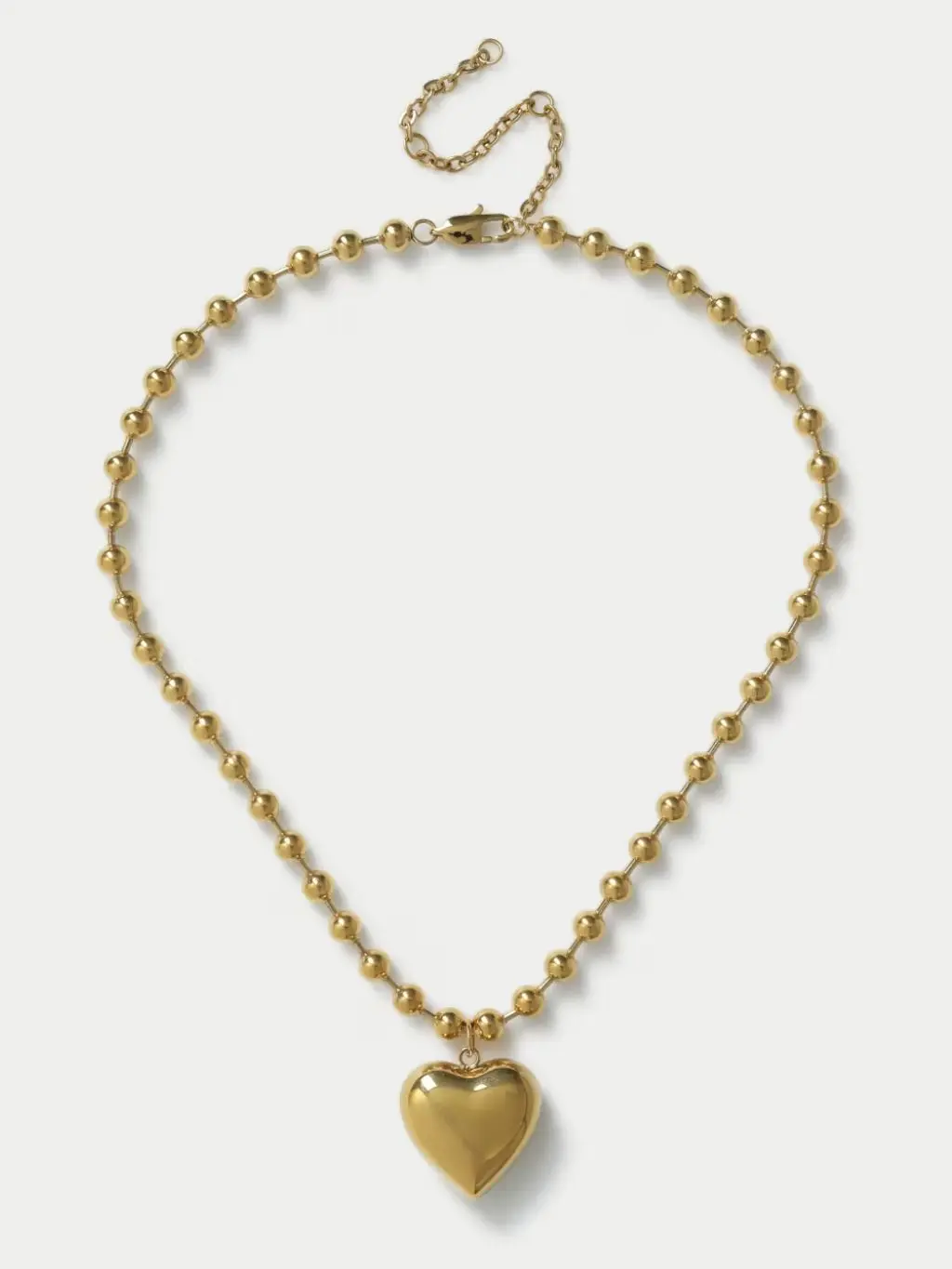 A gold puffy heart necklace