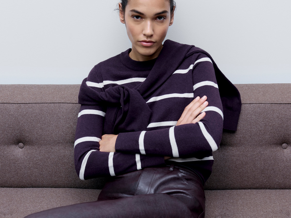 Woman wearing purple striped jumper