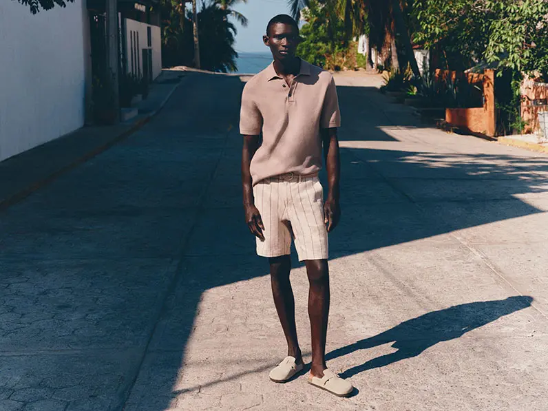 Man in white shorts and polo top