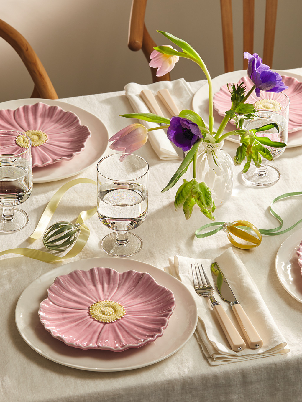 Easter table set with floral tableware and a vase of tulips