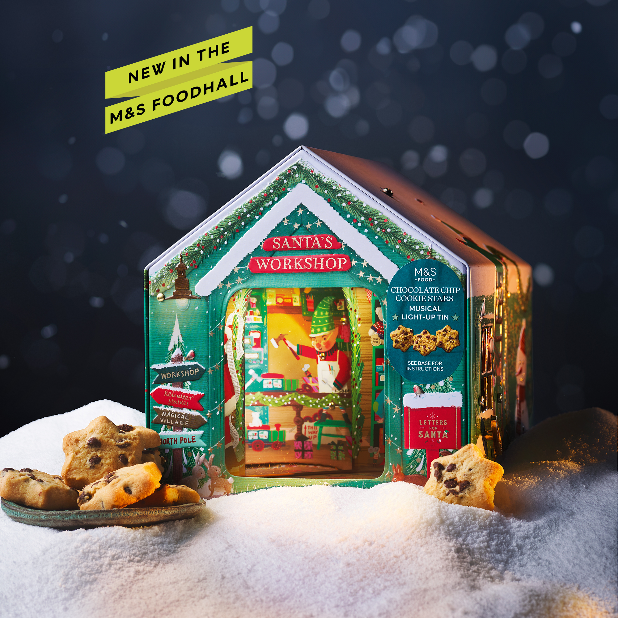 An M&S Santa's Workshop Christmas Biscuit Tin on a snowy scene