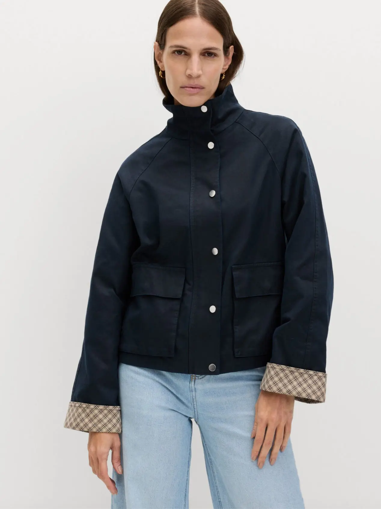 Woman wearing blue jacket with light blue jeans