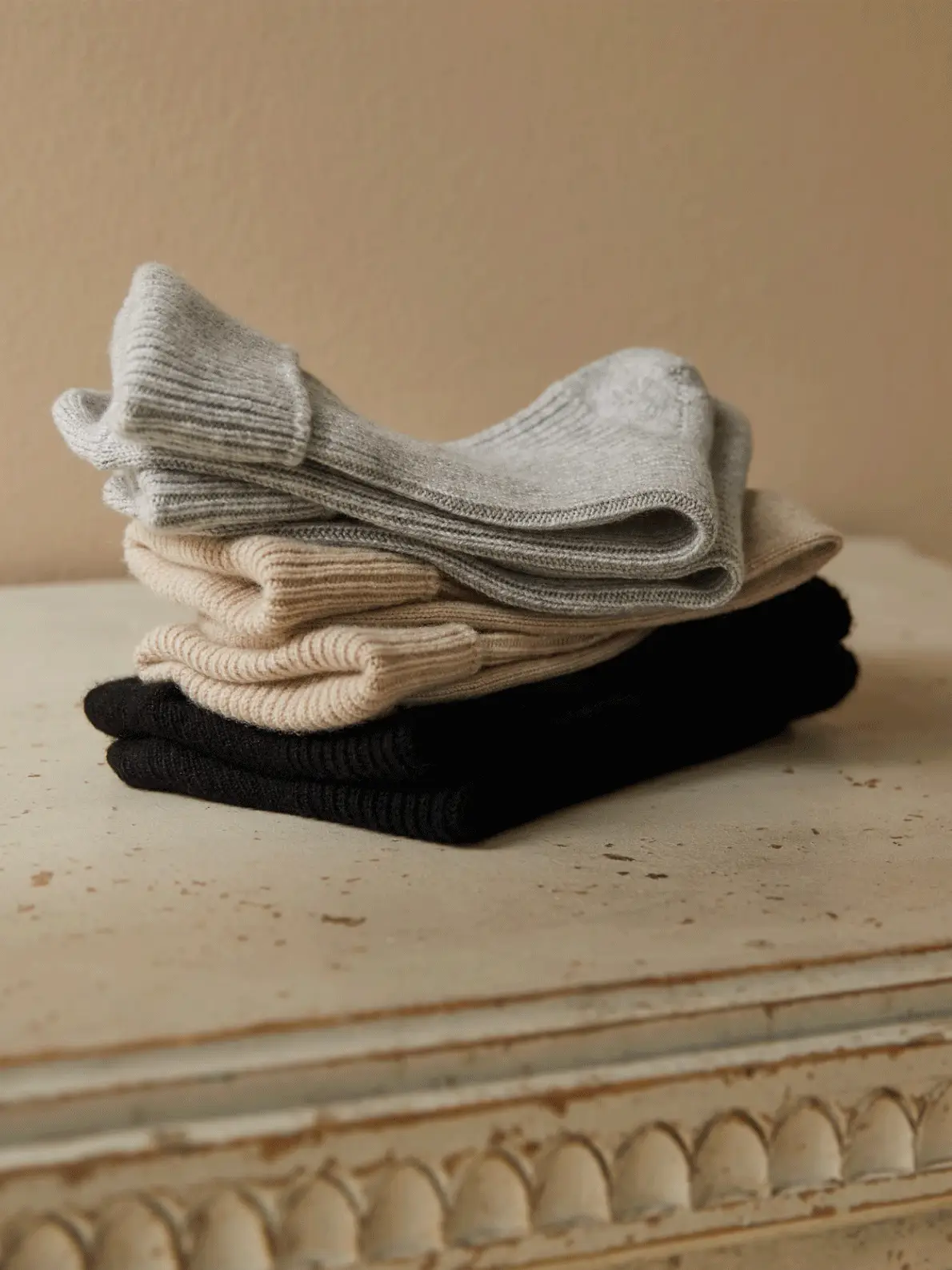 Gif of white hooded sleepsuit, three pairs of socks and two bottles of bath foam