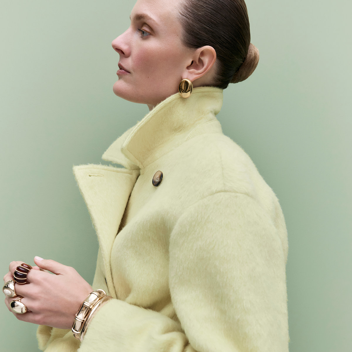 Woman wearing butter yellow coat