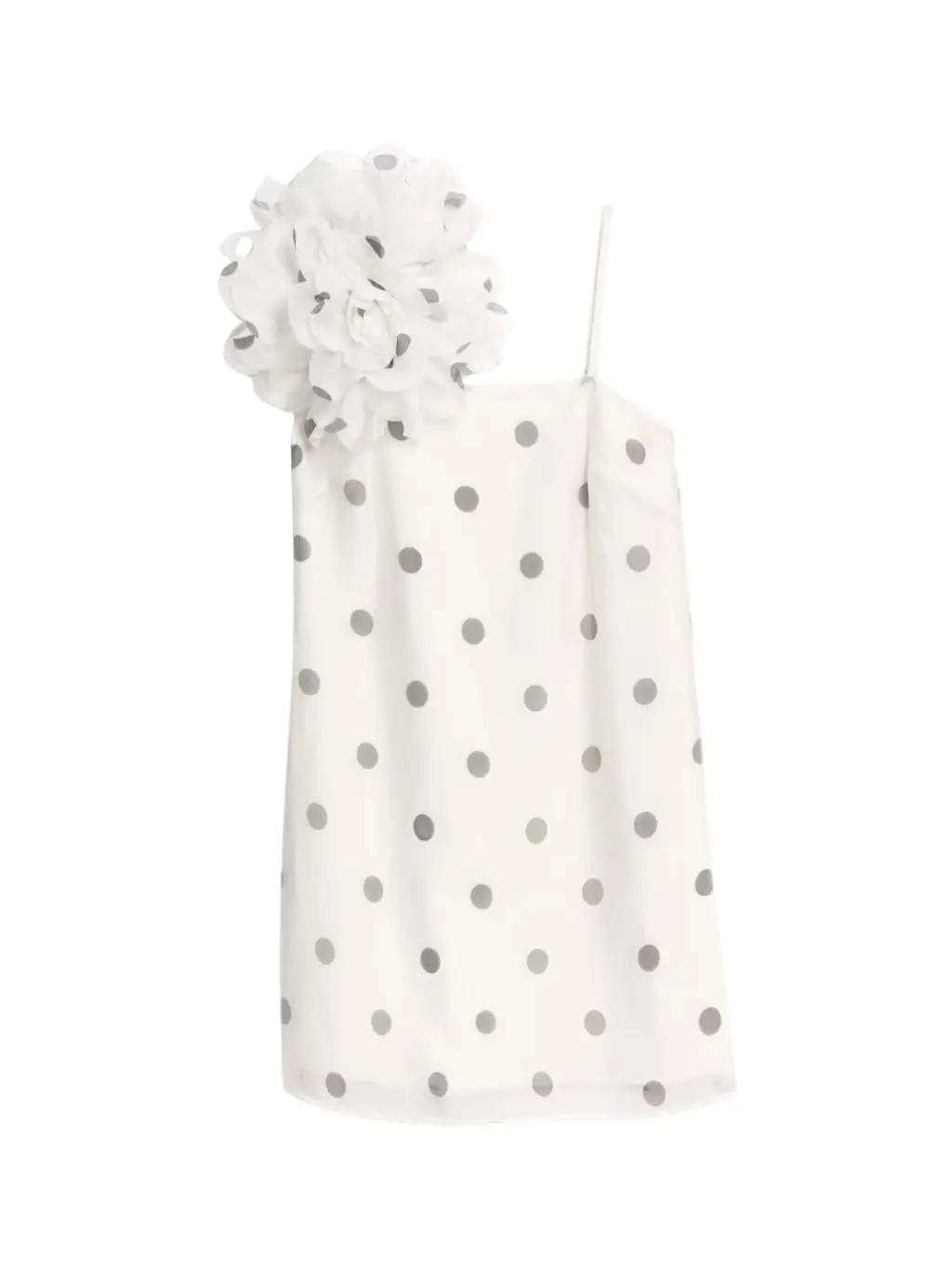 A short mini dress covered in polka dots and with a large corsage on the shoulder