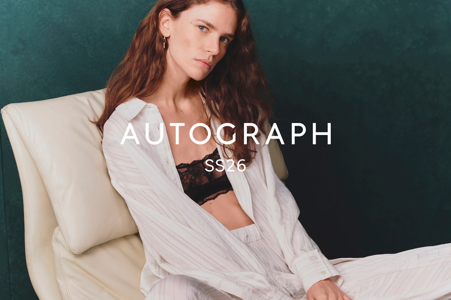 Woman wearing white pyjamas and black bra