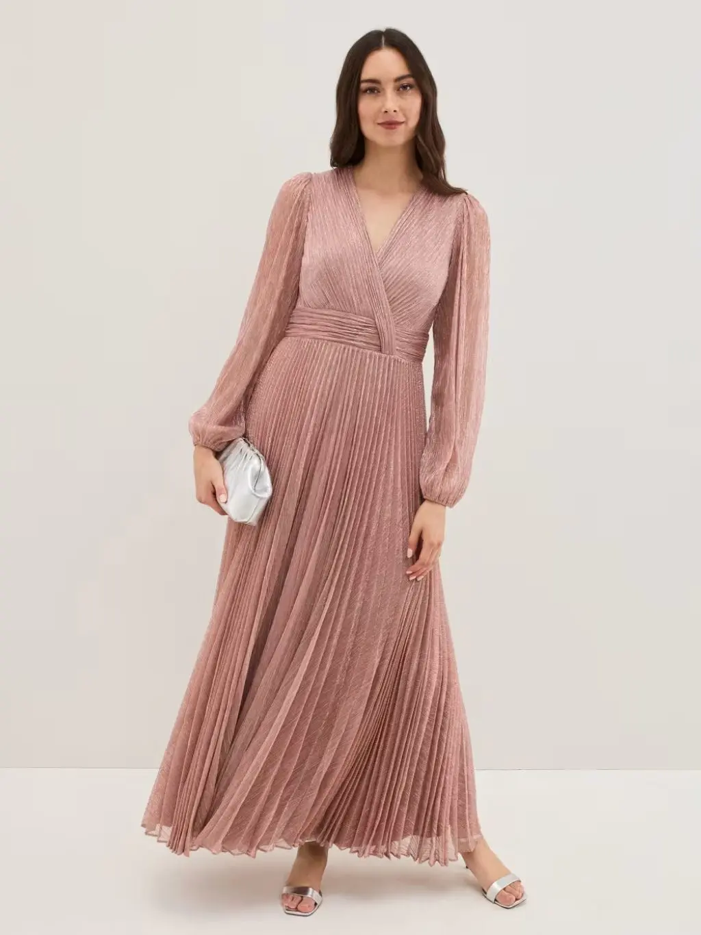 A woman wearing a pink sparkly full length dress
