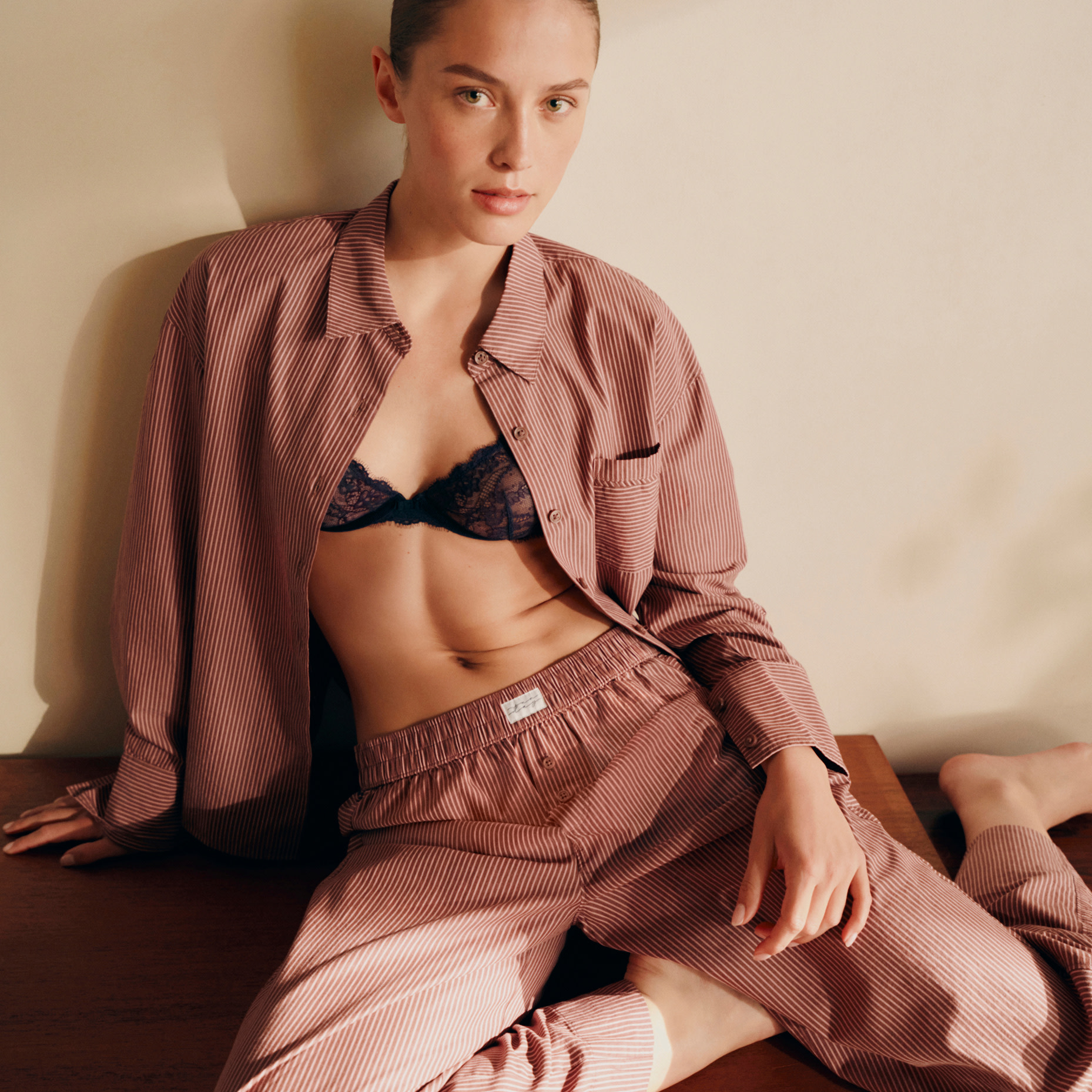 Woman wearing pyjama set over lingerie 