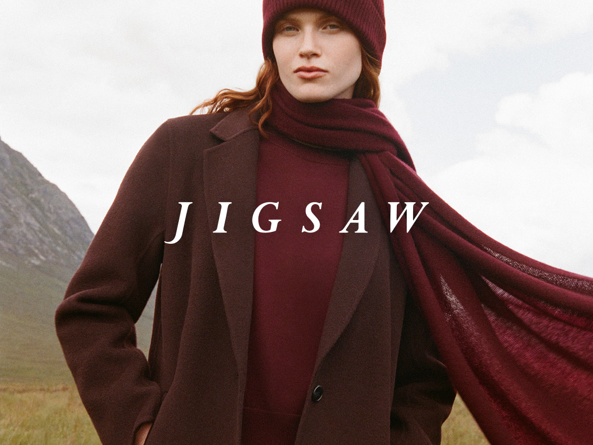 Woman wearing burgundy scarf, brown coat and burgundy jumper by Jigsaw