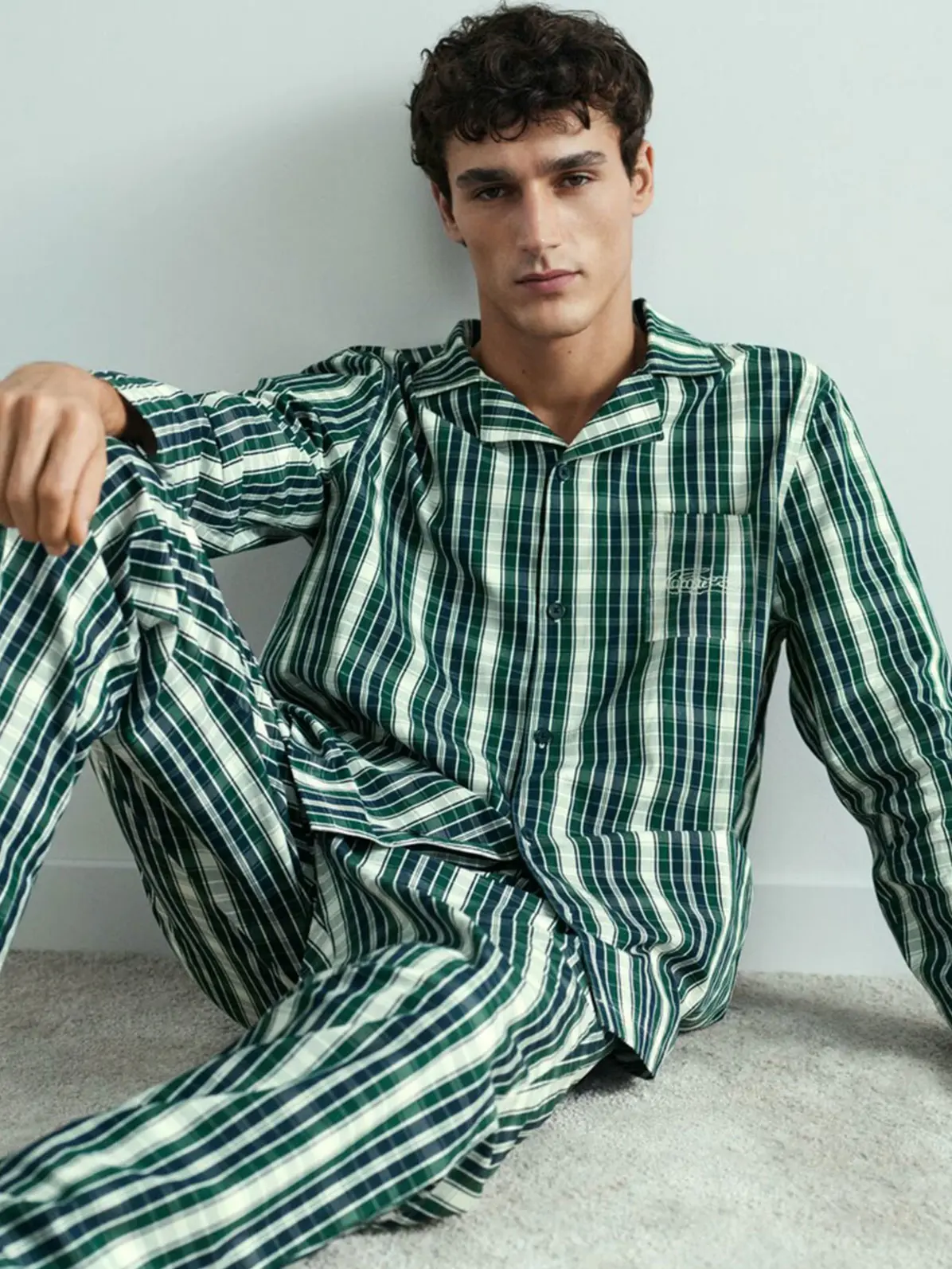 Man wearing green and white checked pyjama set