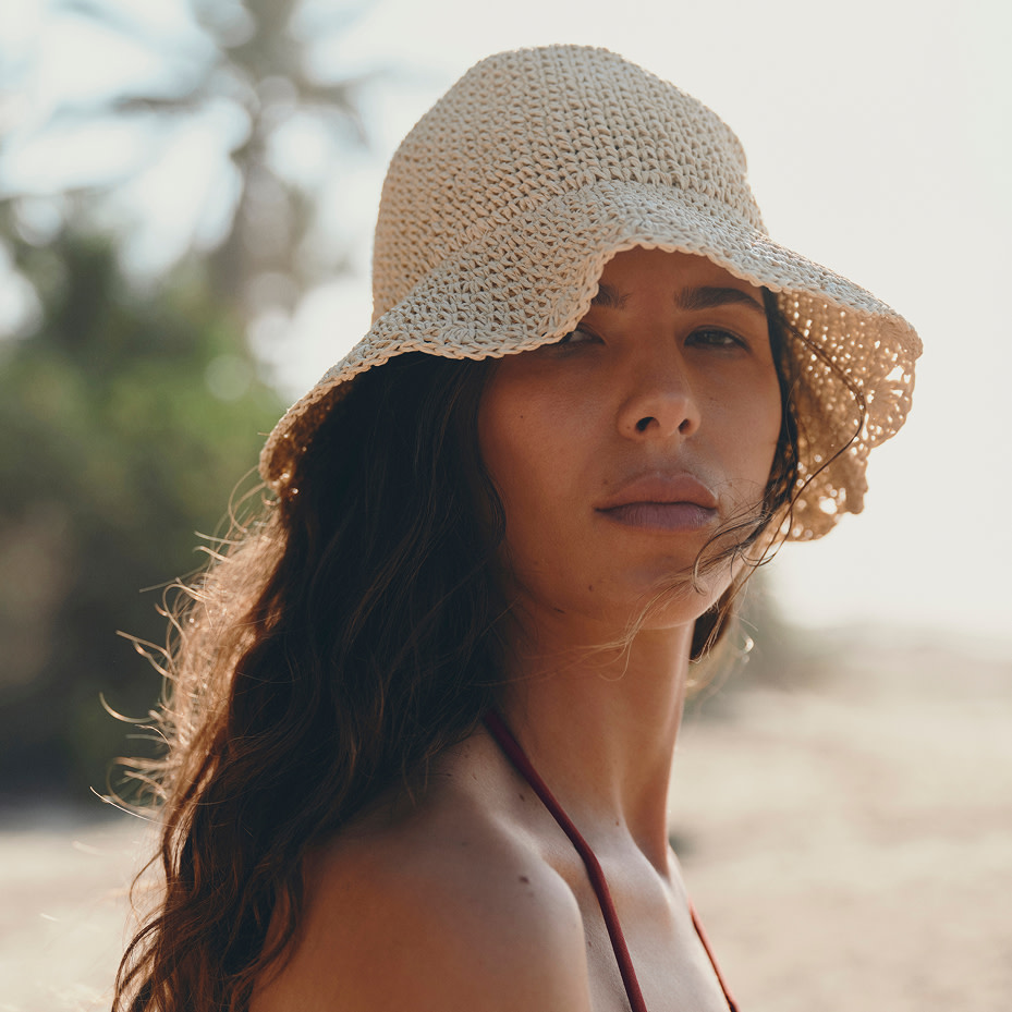 Woman wearing woven hat 