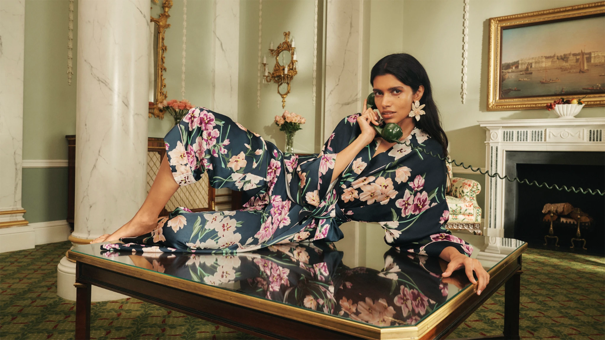 Woman wearing floral-print satin pyjamas by M&S X Olivia von Halle