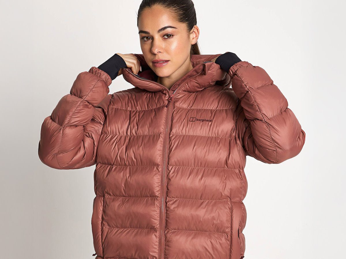 Woman wearing rust coloured puffer coat by Berghaus