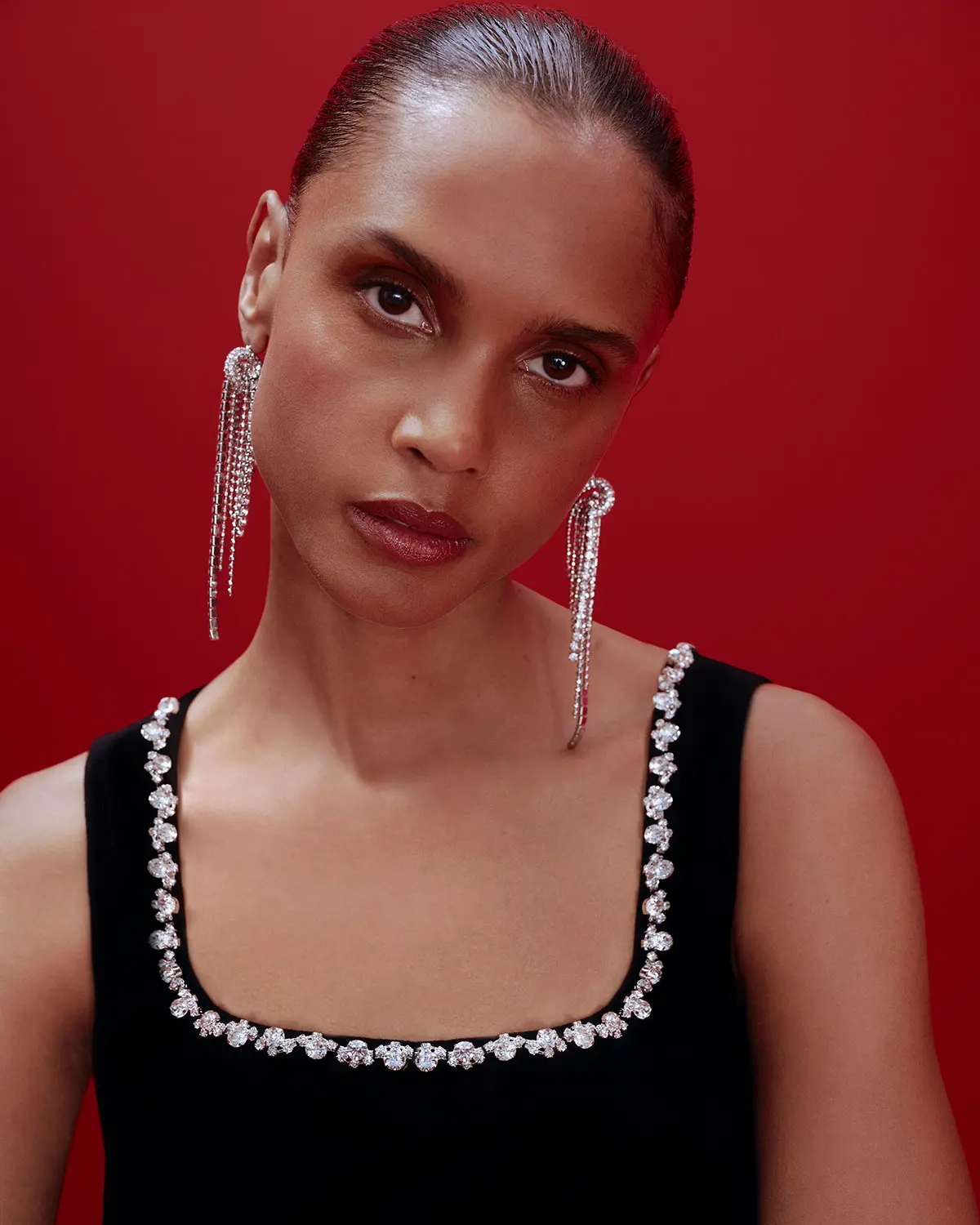 Woman wearing diamante earrings and sequin trimmed dress