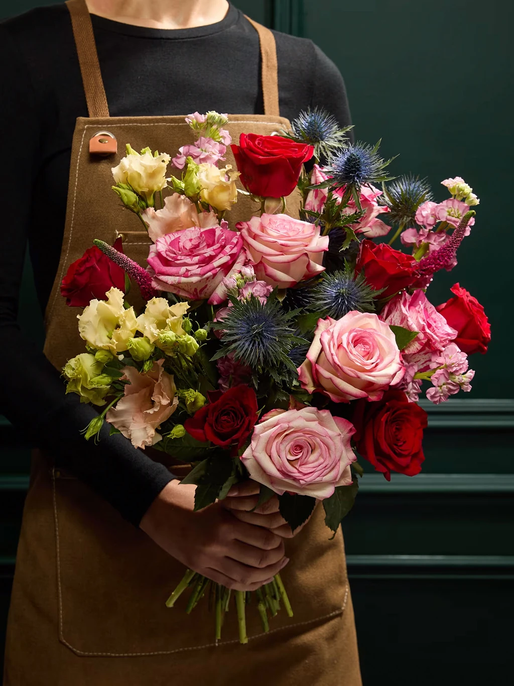 Hand holding bouquet of flowers