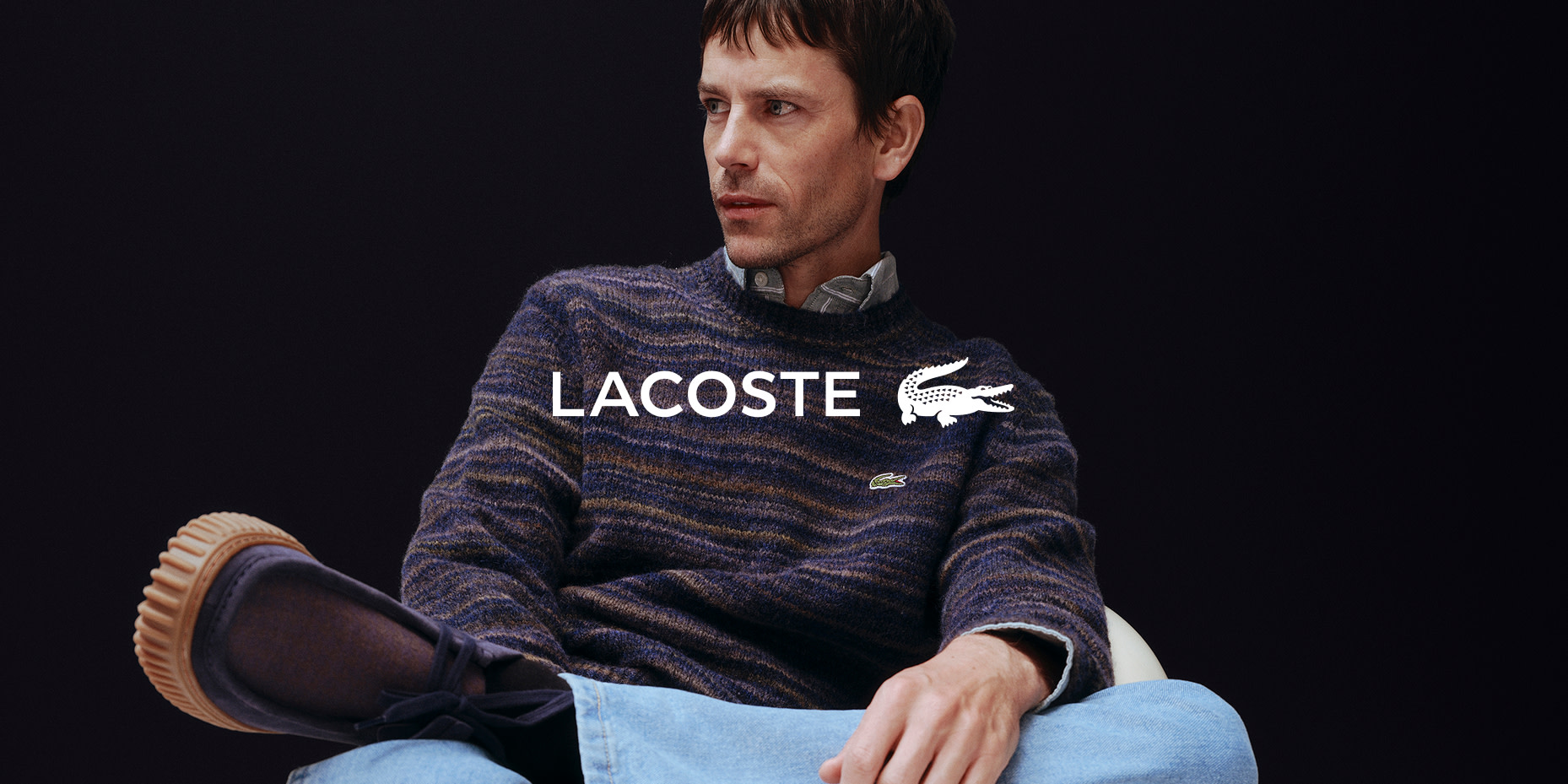 Man wearing jumper and shirt by Lacoste